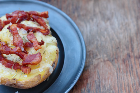 Closeup of cheese and bacon baked potato.の写真素材