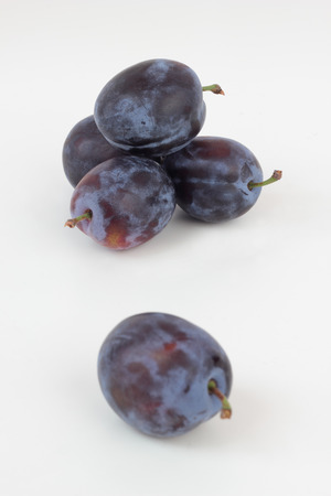 Closeup of ripe plums isolated on white.の写真素材