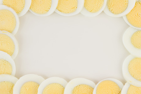 Sliced eggs formed into an isolated egg frame.の写真素材