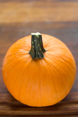 Closeup of pumpkins on a timber cutting board.の写真素材