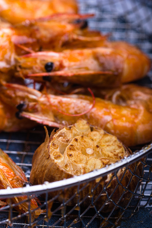 Deep fried prawns and garlic on a blue pate.の写真素材