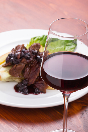 Glass of red wine and thin flank with roman lettuce.の写真素材