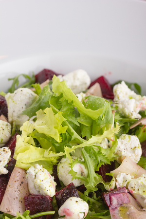 Green salad with marinated beetroot, radish and ricotta cheese.の写真素材