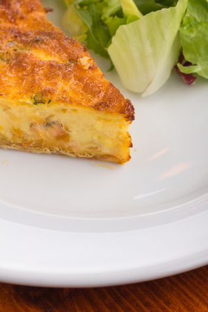 Quiche with broccoli served on a white plate.の写真素材