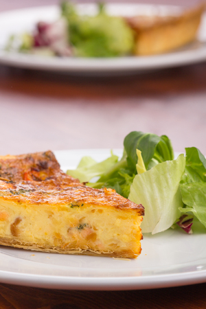 Quiche with broccoli served on a white plate.の写真素材