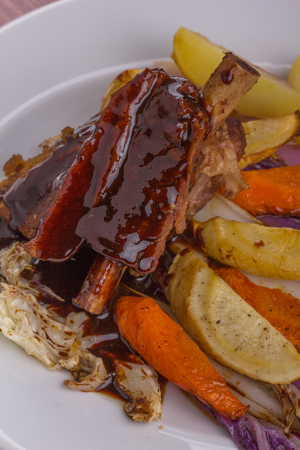 Flat rib with sauted vegetables served on a white plate.の写真素材