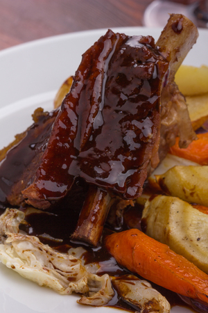Flat rib with sauted vegetables served on a white plate.の写真素材