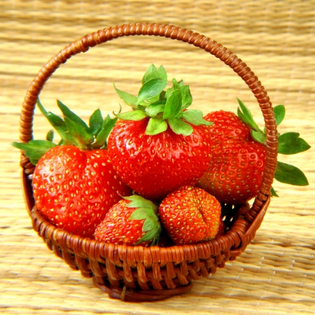 Strawberries in small bamboo basketの写真素材