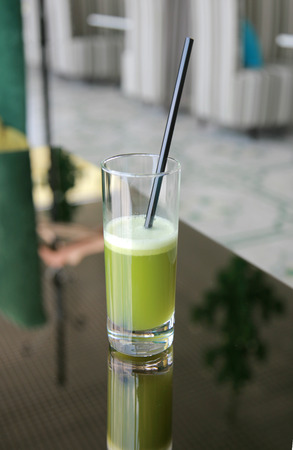 Glass of fresh vegetable celery juice with strawの写真素材