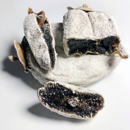Sliced dried persimmons on white plateの写真素材