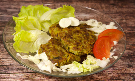 Vegetarian cabbage cutlets with green salad, tomatoes and mozzarella