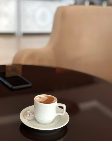 Small white cup of turkish coffee with delight on the table