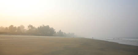 Foggy morning on Varca beach in the golden rays of the sun Goa Indiaの写真素材