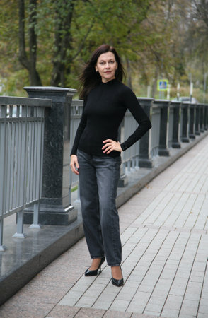 Age model woman 51 years old brunette with loose hair stands in a podium poseの写真素材