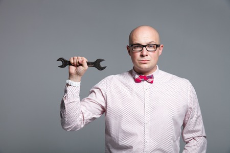 Portrait of business trainer that showing the sales and motivation tools on a grey background in studioの写真素材