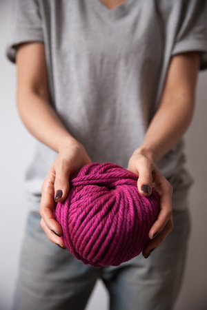 Yarn ball in female hands. Close-up vertical photo. Freelance creative working and living conceptの写真素材