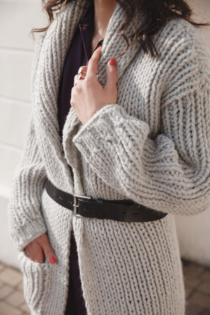 Portrait of young woman wearing colorful knitted clothes. Outdoor, street, lifestyle. Concept of...