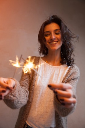 Close-up of sparkler in in woman hands. Concept of happy holliday celebrationの写真素材