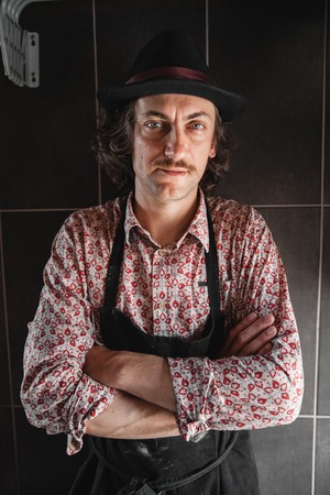 Adult male potter master portrait. Front view, closeup, focus on hands. Art and business, hobby and freelance working concept.の写真素材