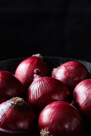 Close-up of red spanish onion with peel - top flat lay view. Healthy raw organic vegetarian food or meal ingredientsの写真素材