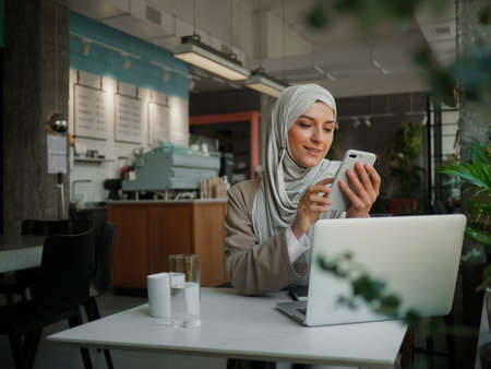Muslim woman on remote working, online education or video conversation in caffeの写真素材