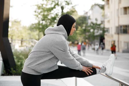 Muslim woman stretching on morning outdoor workoutの写真素材