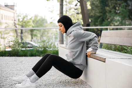 Muslim woman doing exercises on morning outdoor workout