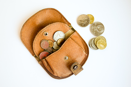Old wallet with coins which have fallen.の写真素材