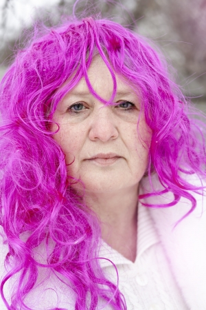 Portrait of an elderly woman in a pink wigの写真素材
