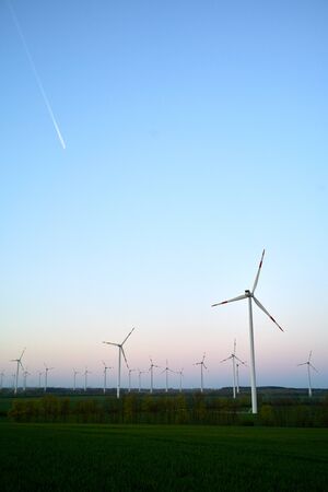 Vestas wind turbines on countryside wind park at sunsetの写真素材