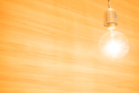 abstract old light bulb on wooden backgroundの写真素材