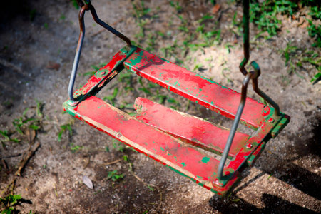 Old stained swing on the woods
