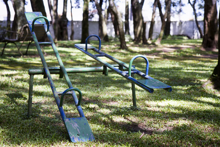 Old stained green seesawの写真素材