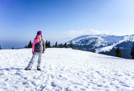 Young smiling woman on the snowy Kopaonik ski slope in ski clothes. Active lifestyleの写真素材