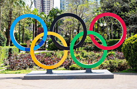 SOCHI, RUSSIA - 30.04.2021 The symbol of the Olympic sports games five-color Olympic rings in the park of the city against the background of green plants