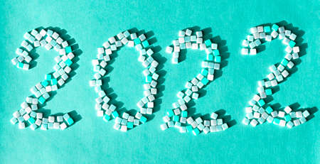 New year 2022 numbers close-up on pastel blue background holiday concept decorationsの写真素材