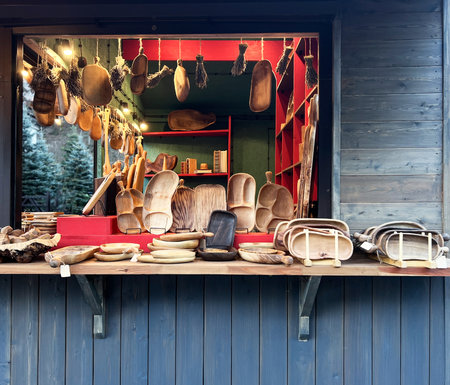market stall filled with assortment handcrafted wooden kitchen, dining accessories, unique serving trays, rustic bowls, cutting boards, natural products, eco-conscious living sustainable home decorの写真素材