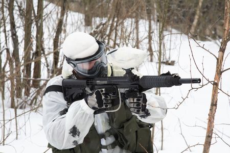 armed men in a camouflage play a paintballの写真素材