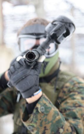 armed men in a camouflage play a paintballの写真素材