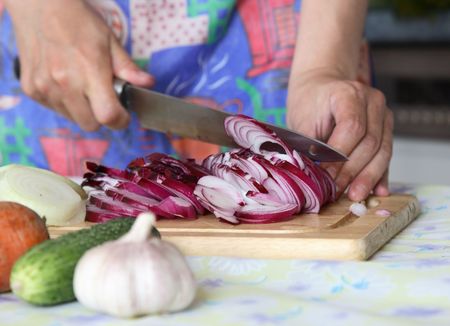 Cutting of onions for preparation of vegetable saladの写真素材