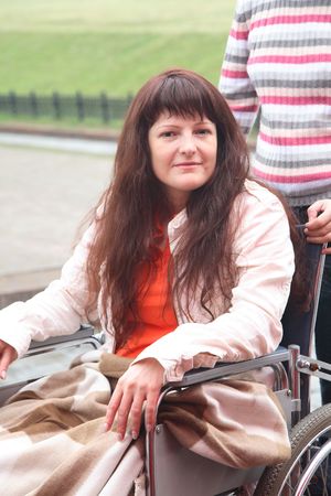 young woman on walk in an invalid carriageの写真素材