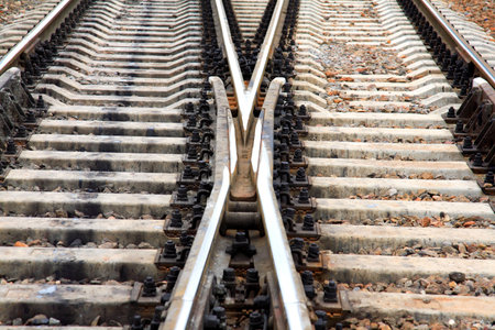 Tracks. Rails. An arrow. A close up.