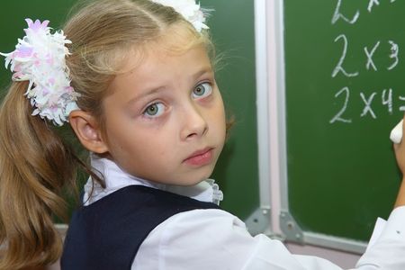 schoolgirl of an elementary grade answers at a boardの写真素材