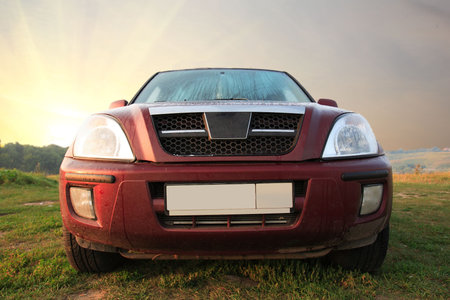 big red car against the morning sky