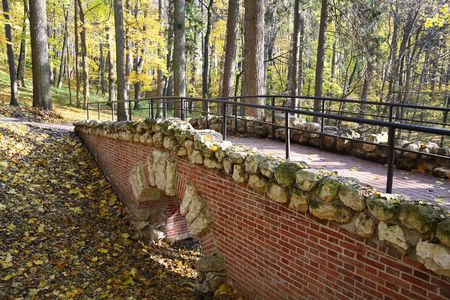 stone bridge through ravine in autumn parkの写真素材