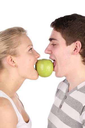 girl and  young man bite together green appleの写真素材