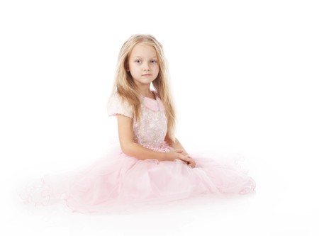 little girl in a pink elegant dress.White backgroundの写真素材