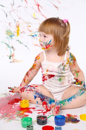 little girl bedaubed with bright colorsの写真素材