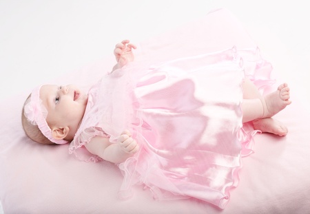 Portrait of the baby - girls in an elegant pink dressの写真素材