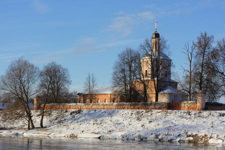 Winter landscape with orthodox church on river bank.の写真素材